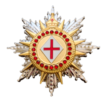 A gold and silver star-shaped badge with a central white diamond displaying a red cross, surrounded by red jewels and spiked rays.