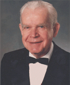 Thurman C pace Thurman C. Pace, Jr.; Past Supreme MAGI; An elderly man with white hair is smiling and wearing a black tuxedo with a black bow tie and white shirt, posed in front of a gray background.