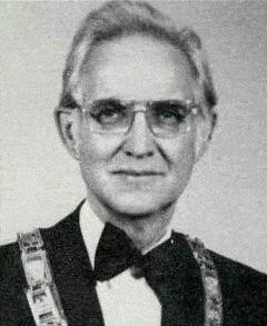 William G. Peacher William G. Peacher; Past Supreme MAGI; Black and white portrait of an older man wearing glasses, a tuxedo, and a ceremonial chain around his shoulders, looking directly at the camera.